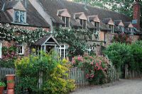 Cottages wreathed in roses at Cothay Manor, Greenham, Somerset