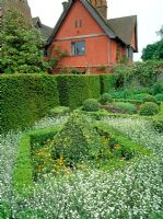 Clipped Buxus and Tacus baccata in the Knot garden at Wyken Hall, Suffolk