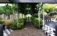 Avenue with Platanus and low growing bamboos. Black and white chequered tiles on the terrace - Hobrede, Holland
