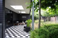 Chequered black and white tiles, Platanus with low growing bamboos - Hobrede, Holland