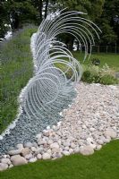 'Wave Dance' pebble beach garden with steel sculpture and Lavandula - Lavender - RHS Tatton Park 2010
 