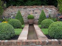 Rill and topiary. The Russell Watkinson Landscapes 'It's a Reflection of Life' garden - RHS Tatton Flower Show 2010