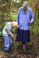 Leonie Woolhouse in the vegetable garden with her grandson, Arthur, learning how to dig - The Old Sun House, Wymondham, Norfolk, NGS 
