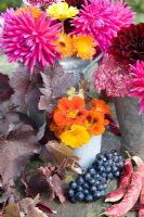 Autumn floral arrangement with Dahlias, Nasturiums, vine foliage and grapes 
