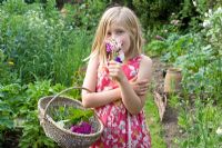 Young girl holding bunch of sweet peas