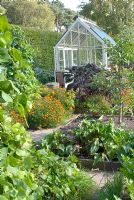 Raised beds in the Kitchen garden, and Alpine greenhouse at Ness Botanical Gardens, Cheshire 