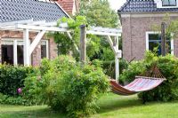 Country garden with pergola and hammock