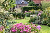 Country garden with planting of Agastache, Monarda, Phlox and Echinacea purpurea