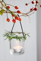 Tealight holder decorated with Rosemary, hanging from garland decorated with Rosehips