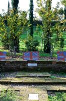 Patio and low stone wall. The Field. Il Bosco Della Ragnaia, San Giovanni D'Asso, Tuscany, Italy, October. 
 