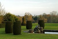 Formal garden with topiary on lawn. Mr and Mrs E Barham, Hole Park, Rolvenden, Kent, UK