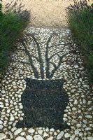 Detail of mosaic pattern in path edged with Lavandula - Lavender. Parsons Cottage, Essex, UK