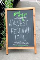 Billboard in street advertising a Harvest Festival organised by Capital Growth, London UK