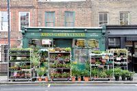 John's Garden Centre with plants for sale displayed on the pavement - Stoke Newington High Street, Hackney, London 