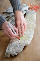 Making Christmas decorations from birch bark - Drawing round the template