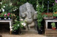 Plants and stone Ganesh statue for sale at Petersham Nurseries, Richmond, Surrey