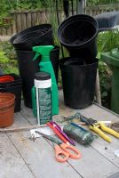 Greenhouse staging with pots, string, scissors, secateurs and chemicals