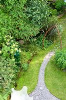 Urban garden viewed from above, showing resin water feature and curved slate path under metal arch. Yulia Badian garden, London, UK