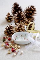 Making pine cone decorations with beads - STEP 2.  All the equipment needed - pine cones, beads, pins and ribbons.