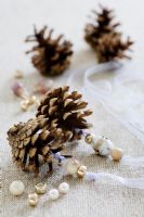 Making pine cone decorations with beads - STEP 6.  Thread beads on to the ribbons