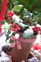 Rusty pot with snowy Ilex - Holly, and ribbon
