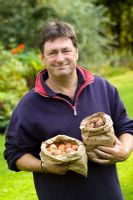 Alan Titchmarsh with packets of bulbs ready to plant