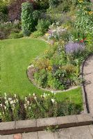 Elevated view of late summer mixed borders with adjacent patio, path and lawn at 'Springbank', Davenham, Cheshire NGS