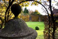 View of lawn with clipped box ball and Fagus hedge - Silverstone Farm, Norfolk