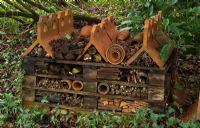 The insect hotel in the woodland garden - Pembury House Gardens, Sussex 
