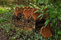 The insect hotel in the woodland garden - Pembury House Gardens, Sussex