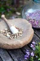 Grinding herbs with a pestle and mortar