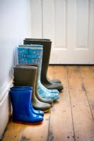 Four pairs of wellies of a gardening family in the hallway. 