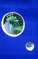 Clair voye. Potager seen through hole in breeze block wall. International Gardens Festival, Chaumont sur Loire. 1999.