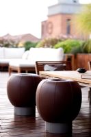 Terrace in Ferrara with seating area and leather stools