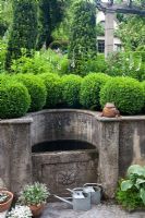 Stone fountain, Buxus sempervirens - Box balls and Taxus baccata - Yew columns