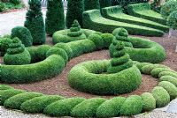 Clipped Buxus - Box and Taxus - Yew in the Parterre Garden. Bourton House, Bourton-on-the-Hill, Moreton-in-Marsh, Glos, UK
