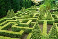 Geometric knot garden of Buxus - Box framed within Taxus - Yew walls, with central basket pond from the Great Exhibition of 1851. Bourton House, Bourton-on-the-Hill, Moreton-in-Marsh, Glos, UK
