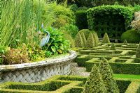 Geometric knot garden of Buxus - Box within Taxus - Yew walls, with central basket pond from the Great Exhibition of 1851. Bourton House, Bourton-on-the-Hill, Moreton-in-Marsh, Glos, UK 
 