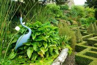 Heron by Michael Lythgoe in basket pond from the 1851 Great Exhibition, the centre piece of the Knot garden. Bourton House, Bourton-on-the-Hill, Moreton-in-Marsh, Glos, UK
