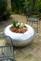Circular silver metal planter of succulents. Bourton House, Bourton-on-the-Hill, Moreton-in-Marsh, Glos, UK