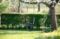 Horse swing made from recycled tyres in Spring garden at Bed and breakfast in Velp, Brabant,  Holland