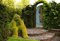 Topiary man grown from Lonicera, and Topiary man in Yew hedge and Blue door in Hedge, Tilford Cottage, Surrey 