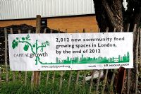 A Capital Growth banner on fence advertising 2012 new community food growing spaces in London by the end of 2012