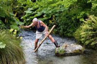 Keith Stuart traversing stream in his garden