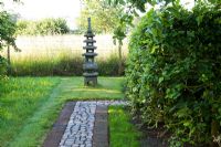 The Corner House, Wiltshire. Summer garden, Japanese temple at end of cobble path