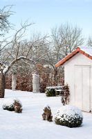 Tool shed in winter garden with snow