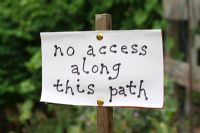 Hand written sign reading 'No access along this path' 
