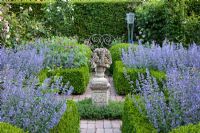 Formal garden with scented borders of Nepeta 'Walkers Low'  - Catmint. Buxus and Taxus hedges