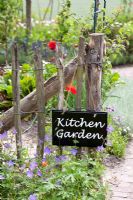 Kitchen garden sign on wooden fence
