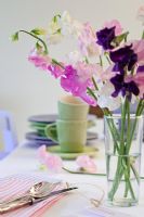 Table setting with Lathyrus - Sweet Peas in glass vase
